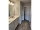 Bathroom with double vanity and wood-look tiled floors at 3765 Davis Cir, Duluth, GA 30096