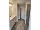 Tiled bathroom with double vanity, glass shower doors and wood-look tiled floors at 3765 Davis Cir, Duluth, GA 30096