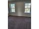 This cozy bedroom features two windows with views and plush carpet flooring at 3765 Davis Cir, Duluth, GA 30096