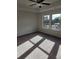 Carpeted bedroom featuring two windows and a ceiling fan at 3765 Davis Cir, Duluth, GA 30096