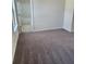 Spacious bedroom with neutral walls and plush carpet flooring leading to an ensuite bath at 3765 Davis Cir, Duluth, GA 30096