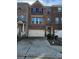 Charming brick townhome with a two-car garage and a well-maintained front yard at 3765 Davis Cir, Duluth, GA 30096