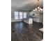 Open-concept living room and kitchen area with dark floors and modern lighting fixtures at 3765 Davis Cir, Duluth, GA 30096