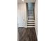 View of a staircase with dark wood treads, white risers, and a modern metal handrail at 3765 Davis Cir, Duluth, GA 30096