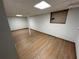 The basement features wood-look floors, white walls, and a support column at 690 Antioch Rd, Powder Springs, GA 30127