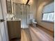 Bathroom with a tiled walk-in shower, modern vanity and hardwood floors at 690 Antioch Rd, Powder Springs, GA 30127