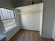 Bright, simple closet with hardwood floors and a scenic window view at 690 Antioch Rd, Powder Springs, GA 30127