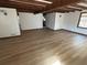 Open-concept living area with beamed ceilings, hardwood floors, and abundant natural light at 690 Antioch Rd, Powder Springs, GA 30127