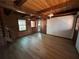 An open living room with wood beam ceilings, hardwood floors and rustic wooden accents at 690 Antioch Rd, Powder Springs, GA 30127