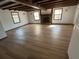 Spacious living room with beamed ceiling, hardwood floors and a stone fireplace at 690 Antioch Rd, Powder Springs, GA 30127