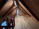 Open loft area featuring wood-paneled walls and ceiling and hardwood floors at 690 Antioch Rd, Powder Springs, GA 30127