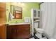 Bathroom featuring a wood vanity, cabinet storage, and modern fixtures at 2169 Tiffany Ln, Lithonia, GA 30058