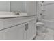 This bathroom has a white vanity, toilet, bathtub, and tile floors at 3614 Arrow Root Cir, Loganville, GA 30052