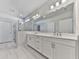 Bathroom featuring a double vanity, modern lighting, and a glass-enclosed shower at 3614 Arrow Root Cir, Loganville, GA 30052