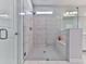 Bright bathroom featuring a frameless glass shower, stylish tile, and a built-in bench for added convenience at 3614 Arrow Root Cir, Loganville, GA 30052