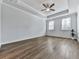 Bright and spacious bedroom with tray ceilings, large windows, and wood-look flooring at 3614 Arrow Root Cir, Loganville, GA 30052