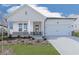 Charming single-story home with a two-car garage and professionally landscaped front yard at 3614 Arrow Root Cir, Loganville, GA 30052