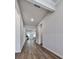 Bright hallway with hardwood floors leading into a well-lit living space with a kitchen beyond at 3614 Arrow Root Cir, Loganville, GA 30052