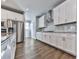 Modern kitchen with stainless steel appliances, sleek white cabinets, and granite countertops at 3614 Arrow Root Cir, Loganville, GA 30052