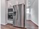 Stainless steel refrigerator and microwave compliment the built in oven in this neutral kitchen at 3614 Arrow Root Cir, Loganville, GA 30052