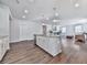 Open kitchen design with granite countertops, stainless steel appliances, and a view of the living room at 3614 Arrow Root Cir, Loganville, GA 30052