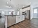 Well-lit kitchen featuring a stainless steel dishwasher, granite countertops and a kitchen island at 3614 Arrow Root Cir, Loganville, GA 30052