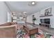 Bright and airy living room with hardwood floors, fireplace, and open floor plan flowing into the kitchen at 3614 Arrow Root Cir, Loganville, GA 30052