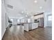 Open-concept living area featuring stainless steel appliances, kitchen island and hardwood flooring at 3614 Arrow Root Cir, Loganville, GA 30052