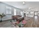 Bright and airy living room with hardwood floors and open floor plan flowing into the kitchen at 3614 Arrow Root Cir, Loganville, GA 30052