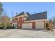 Rear exterior view of brick home showcasing a well-manicured lawn and a 3 car garage at 1414 Lynchburg Trce, Grayson, GA 30017