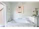 Luxury bathroom featuring a soaking tub, marble surround, and stylish accents at 2525 Peachtree Ne Rd # 25, Atlanta, GA 30305