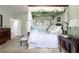 A cozy bedroom boasts a four-poster bed with decorative fabrics, hardwood floors, and soft natural light at 2525 Peachtree Ne Rd # 25, Atlanta, GA 30305