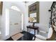 Elegant foyer with white walls, dark wood floors, and a statement mirror, leading to the rest of the home at 2525 Peachtree Ne Rd # 25, Atlanta, GA 30305