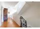 Hallway with hardwood floors and a decorative iron railing, accented by a decorative wooden armoire at 2525 Peachtree Ne Rd # 25, Atlanta, GA 30305