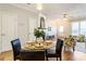 Bright dining area with a glass table, black chairs, and a view to living room at 282 Devonshire Dr, Alpharetta, GA 30022