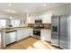 Bright kitchen featuring stainless steel appliances, white cabinetry, and an eat-in bar at 282 Devonshire Dr, Alpharetta, GA 30022