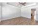Bright bedroom features hardwood floors, ceiling fan, and tray ceilings for a luxurious feel at 2989 Chene Pl, Duluth, GA 30097