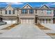 Charming brick townhome featuring a two-car garage and well-maintained landscaping at 2989 Chene Pl, Duluth, GA 30097