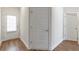 Hallway featuring hardwood floors, white doors, and bright, neutral walls at 2989 Chene Pl, Duluth, GA 30097