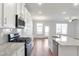 Modern kitchen with stainless steel appliances, granite countertops, and hardwood floors at 2989 Chene Pl, Duluth, GA 30097