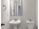 Well-lit powder room with pedestal sink, toilet, and modern fixtures at 2989 Chene Pl, Duluth, GA 30097
