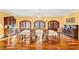 Formal dining room with wood floors, elegant chandelier, and antique cabinets set the scene for elegant dinner parties at 4001 Pool Rd, Winston, GA 30187