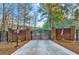 Grand brick and iron gated entrance with American flags on a sprawling estate driveway at 4001 Pool Rd, Winston, GA 30187