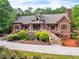 Majestic brick home with lush landscaping, a stone staircase, and a tranquil pond creates a serene outdoor setting at 4001 Pool Rd, Winston, GA 30187