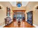 Grand foyer featuring custom wood trim, a chandelier, hardwood floors, and antique furniture exudes timeless elegance at 4001 Pool Rd, Winston, GA 30187