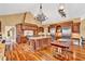 Gourmet kitchen featuring custom wood cabinetry, granite countertops, stainless steel appliances, and elegant chandeliers at 4001 Pool Rd, Winston, GA 30187