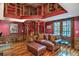 Cozy living room with a spiral staircase and book shelves, rich wood floors, and comfortable seating at 4001 Pool Rd, Winston, GA 30187