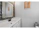 Stylish powder room with a modern vanity, decorative mirror, and unique tile backsplash at 2971 Montview Sw Dr, Marietta, GA 30060