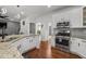 Well-lit kitchen with stainless steel appliances, granite countertops, and warm wood floors at 2971 Montview Sw Dr, Marietta, GA 30060