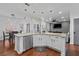 Bright, white kitchen features stainless steel appliances, granite countertops and a central island with modern pendant lighting at 2971 Montview Sw Dr, Marietta, GA 30060
